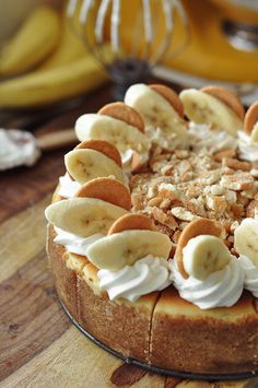 there is a cake with bananas and whipped cream on the top, along with other toppings