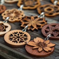 several wooden key chains with different designs on them