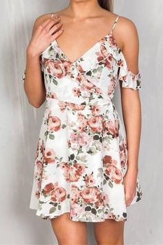 Our Floral Ruffled Wrap Around Mini Dress adds just the right amount of sexy to a girl next door look. With soft ruffles, this dress wraps around your body to tie in the back for the right fit. This beauty with its pretty ivory floral print and cold shoulder would be perfect for many of your spring and summer events! Cold Shoulder Ruffled Wrap around body, tie in back Plunge V Neck Made in the USA 95% Polyester, 5% Spandex Size Small: 30" Length, Bust 34" Sizing is adjustable Small 0-4, Medium 6 Girl Next Door Look, Light Blue Mini Dress, Beach Mini Dress, Mini Sundress, Polly Dress, Pin Up Dresses, Mini Skater Dress, Halter Mini Dress, Mini Sweater Dress