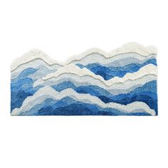 a blue and white rug with wavy waves on the top, in front of a white background