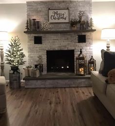 a living room filled with furniture and a fire place in front of a christmas tree