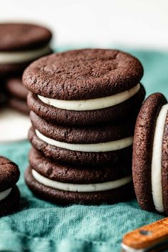 chocolate cookies with white frosting stacked on top of each other