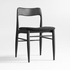 a black chair sitting on top of a white floor next to a wooden frame and seat