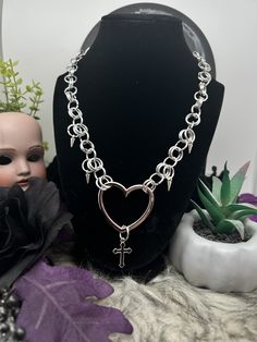 Handmade Chain Mail Necklace featuring a heart centerpiece with cross and spikes!  ꘎ 𝔸𝕓𝕠𝕦𝕥 ❥ Makes the perfect gift! ❥ Made of Aluminum Rings ❥ Adjustable Length at back, let me know if you want an extension! ꘎꘎ 𝕊𝕙𝕚𝕡𝕡𝕚𝕟𝕘 ❥Can take up to 7 days or more to ship out! Alternative Metal Jewelry For Cosplay, Silver Alternative Jewelry For Cosplay, Silver Emo Style Necklace For Festivals, Silver Emo Necklace For Festival, Emo Style Festival Jewelry With Chain, Silver Grunge Style Jewelry For Cosplay, Silver Emo Necklace For Concerts, Emo Metal Necklace For Concerts, Silver Emo Necklace For Concert