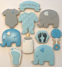 baby shower cookies are arranged in the shape of an elephant, elephant and giraffe