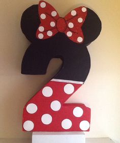 the number two is decorated with polka dots and a minnie mouse bow on it's head