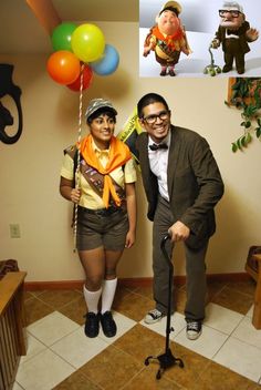 a man and woman dressed up in costume posing for a photo with balloons on the wall behind them