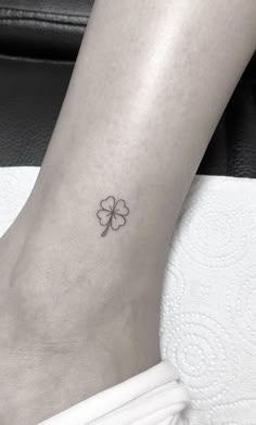 a small four leaf clover tattoo on the ankle