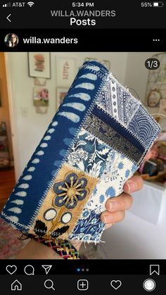 someone is holding up a cell phone case that has been decorated with blue and white designs