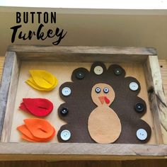 a wooden tray with buttons on it and a turkey cutout in the middle, surrounded by leaves