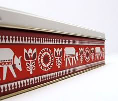 a close up of a red and white wall hanging on a wall with an elephant design