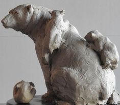 a sculpture of a bear sitting on top of a table