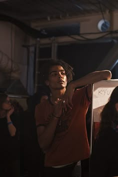 a man holding up a white sign in front of people