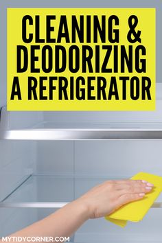 a person cleaning and deodrigating a refrigerator with a yellow sponge on it