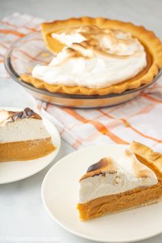 two slices of pumpkin pie on white plates