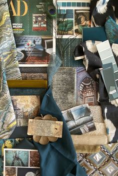 a person holding a piece of fabric next to some pictures and other items on a table