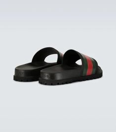 Accented with the label’s signature green and red stripes, these Gucci Web slider sandals are crafted entirely from rubber and feature a molded footbed, and track sole..Made in Italy.Designer color name: Black.Fits small to size - we recommend trying one size larger.UK sizes Green Round Toe Slides With Rubber Sole, Green Cushioned Slip-on Slides, Green Slip-on Slides With Rubber Sole, Green Flat Slides With Removable Insole, Green Slides With Textured Footbed, Green Slides With Round Toe, Rubber Sole Slide Sport Sandals, Casual Beach Slides With Red Sole, Gucci Leather Slip-on Slides