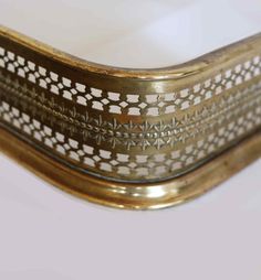 an ornately decorated brass frame on a white background