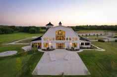 an aerial view of a large white barn with lots of windows on the front and side