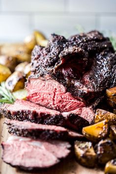 roast beef and potatoes on a cutting board