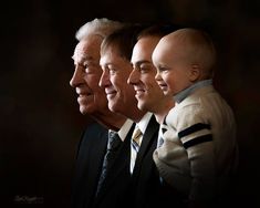 three older men and one younger man are smiling at each other with the same child on their shoulders