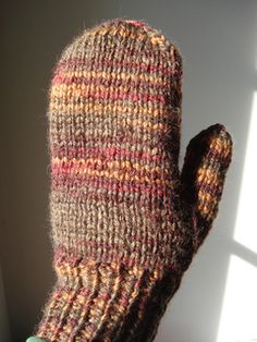 the mittens are made out of wool and have been knitted with yarn