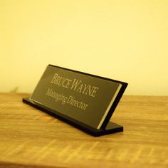 a business card holder sitting on top of a wooden table