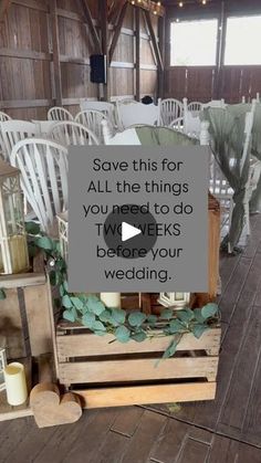 a wooden crate filled with lots of white chairs and greenery on top of it