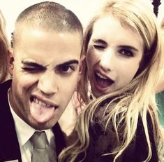 two people posing for the camera with their mouths open and one person sticking his tongue out