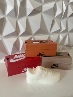 three boxes with nike shoes in them on a table