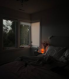 a dimly lit room with a bed and window