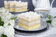 a piece of cake sitting on top of a blue and white plate next to flowers