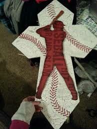 a person holding up a paper cut out of a baseball player