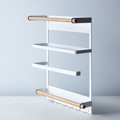 a white and black shelf with wooden handles