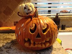 a carved pumpkin sitting on top of a kitchen counter