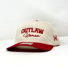 Introducing the 'Outlaw Woman Trucker Hat,' the perfect accessory for women who want to make a statement. This trucker hat is made to last, designed with high-quality materials that can endure any outdoor adventure. The hat features a classic trucker style with a curved brim and adjustable snapback closure, making it comfortable and easy to wear. The black mesh backing ensures ample ventilation, keeping you cool even on hot summer days.The front of the hat boasts an embroidered design of an outlaw woman on horseback, flaunting her fearless spirit and free-spirited nature. The contrasting white stitching adds an extra pop of style.Whether you're hitting the trails or running errands around town, this 'Outlaw Woman Trucker Hat' will elevate your outfit while protecting your face from harmful Cowgirl Trucker Hat, Women Trucker Hat, Embroidered Trucker Hats, Western Trucker Hats, Woman On Horseback, Trendy Trucker Hats, Golf Fits, Trucker Hat Outfit, Red Trucker Hat