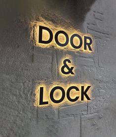 the door and lock sign is lit up with yellow lights on it's side