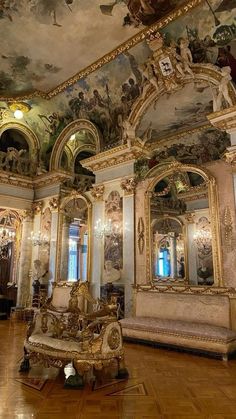 an ornately decorated room with paintings on the ceiling