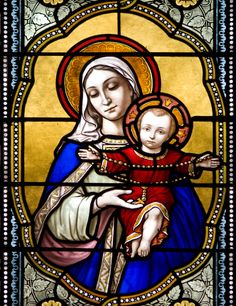 a stained glass window depicting the virgin and child