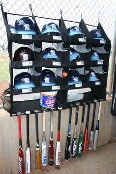 a rack with baseball bats and helmets on it