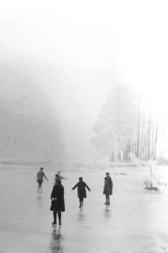 several people are walking in the snow on a cold day