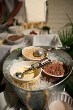 bowls of ice cream and other desserts on a table