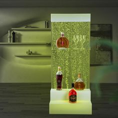 two bottles of liquor sitting on top of a white shelf in front of a mirror