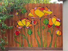 a wooden fence with flowers painted on it