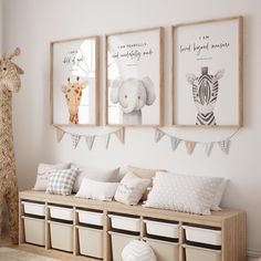 a room with three pictures hanging on the wall and two stuffed animals in baskets next to it