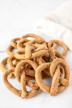 a pile of pretzels sitting on top of a white table