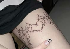 a woman's leg with tattoos on it and a tattoo design on the side