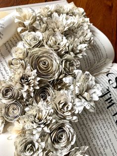 an open book with paper flowers on it