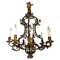 an ornate chandelier with five lit candles