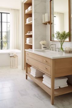 a bathroom with marble counter tops and wooden cabinets